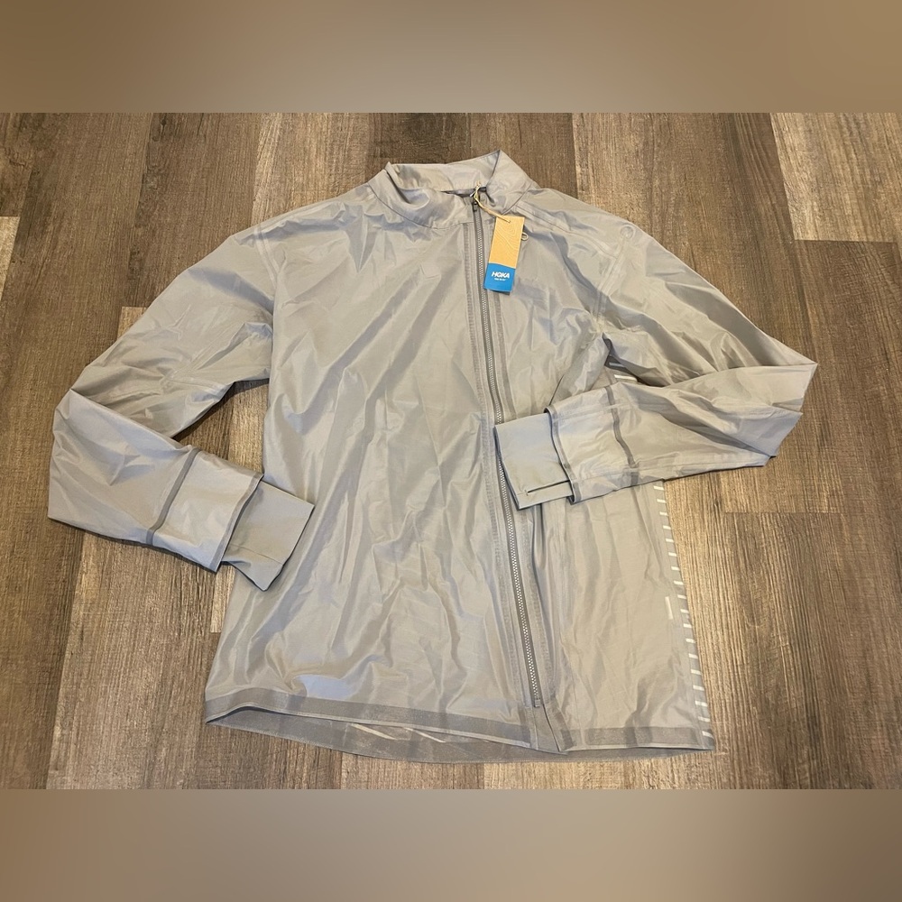 HOKA ONE ONE Performance Shield Running Jacket.
- Size XS Men Available.